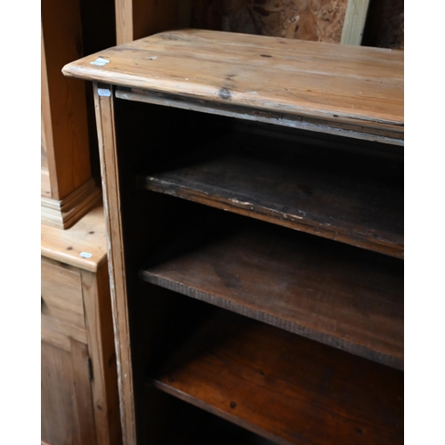 28 - An antique pine low open bookcase with adjustable shelves