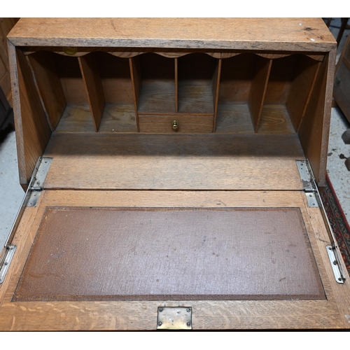 32 - # A golden oak fall front bureau over two drawers and raised on an open base