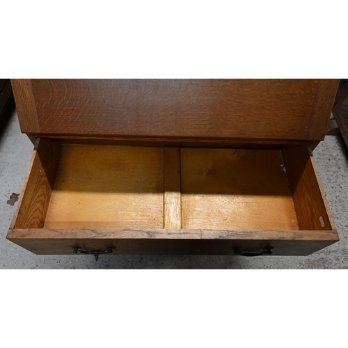 32 - # A golden oak fall front bureau over two drawers and raised on an open base