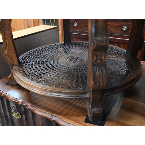 33 - A circular walnut low centre/coffee table with cane panelled undertier