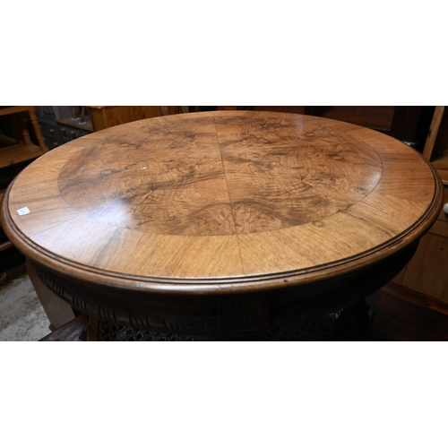 33 - A circular walnut low centre/coffee table with cane panelled undertier