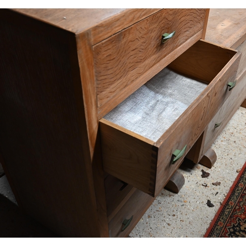 35 - A mid-century limed oak four drawer chest raised on sledges to/with a matching two drawer mirror bac... 