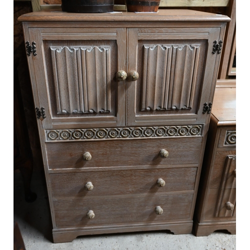 37 - # A mid-century limed oak mirror backed kneehole dressing table to/with a companion dwarf press cupb... 