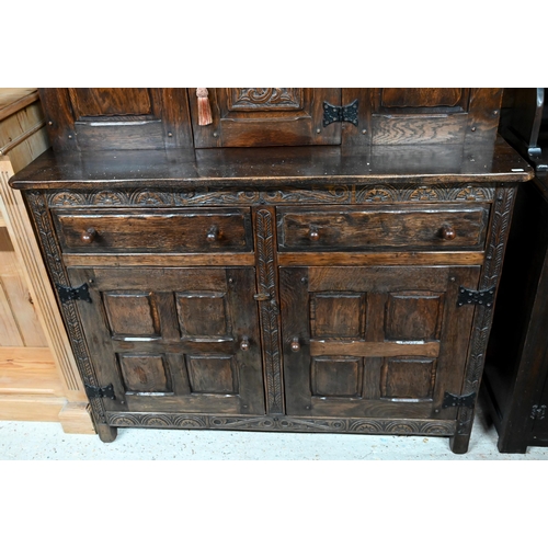 41 - # A traditional Old Charm style oak court cupboard, with carved lunette decoration