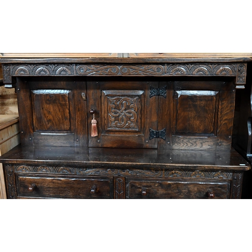 41 - # A traditional Old Charm style oak court cupboard, with carved lunette decoration