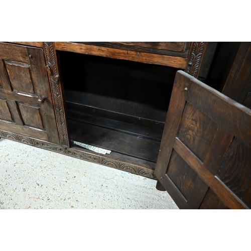 41 - # A traditional Old Charm style oak court cupboard, with carved lunette decoration