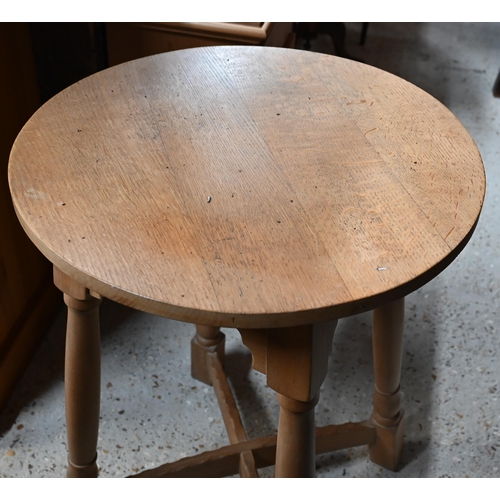 43 - A traditional golden oak circular occasional table on four turned legs united by cross stretcher to/... 