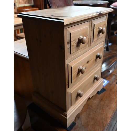 43 - A traditional golden oak circular occasional table on four turned legs united by cross stretcher to/... 