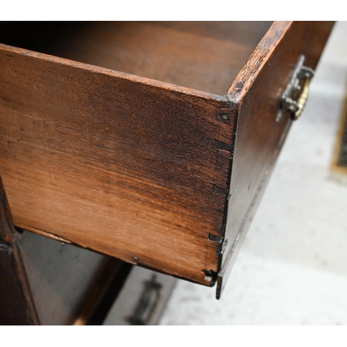 46 - An 18th century and later oak chest of  two short over three long graduated drawers, raised on shape... 