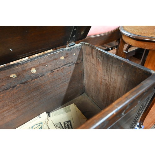 47 - An old part carved oak coffer, raised on shaped bracket sleigh ends