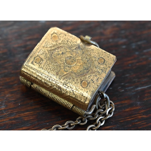 502 - A miniature Koran with tooled leather cover (disbound) dated 1317 (1897, possibly), in gilt brass pe... 