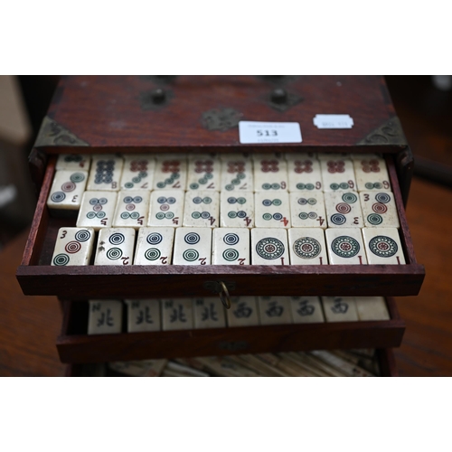 513 - An antique bone and bamboo Mah Jong set, in brass-mounted teak fitted case with five drawers (replac... 