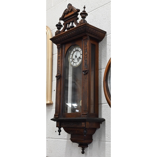 530 - # A German carved walnut Vienna-style wall clock, 98cm high