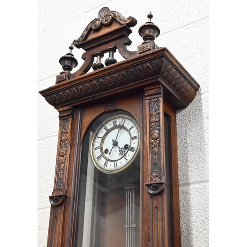 530 - # A German carved walnut Vienna-style wall clock, 98cm high