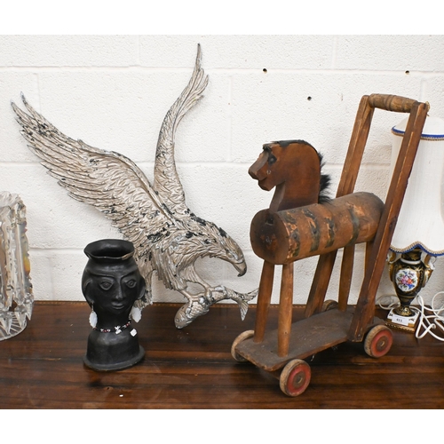 541 - A vintage wooden push-along toy horse, to/w a cast aluminium 'eagle' wall plaque and an African eart... 