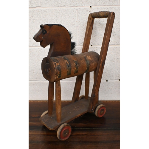 541 - A vintage wooden push-along toy horse, to/w a cast aluminium 'eagle' wall plaque and an African eart... 