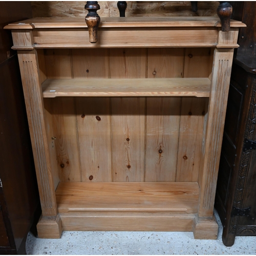 57 - A modern pine low open bookcase with two adjustable shelves, on a plinth base