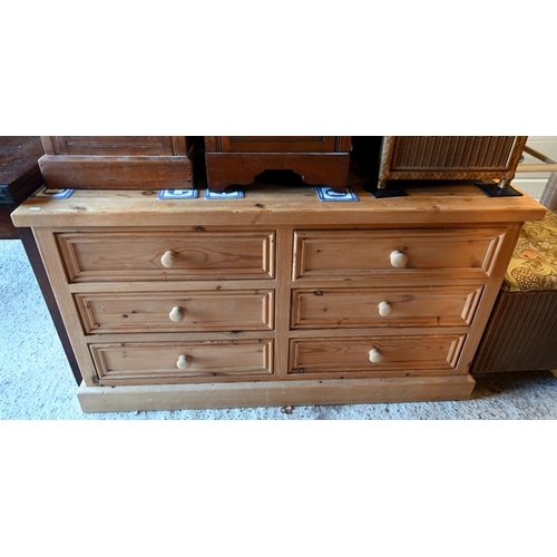 62 - A modern pine six drawer low sideboard/chest, on a plinth base