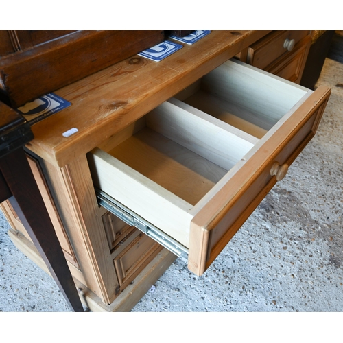 62 - A modern pine six drawer low sideboard/chest, on a plinth base