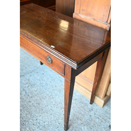 64 - A Victorian mahogany fold over double gateleg tea table, with single frieze drawer, raised on square... 