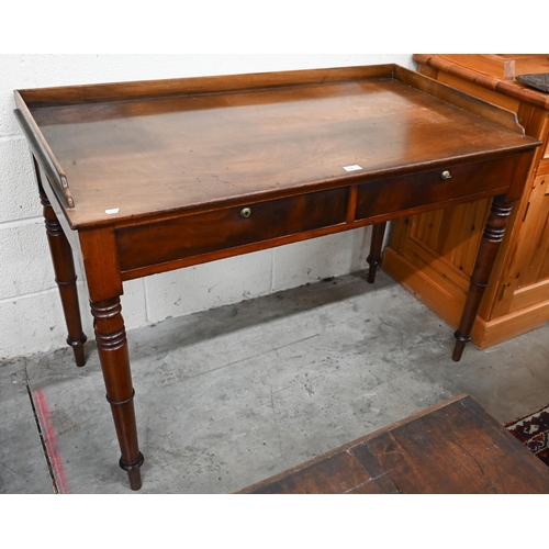 66 - An antique mahogany dressing table with two drawers and turned supports, 114 cm w x 60 cm d x 80 cm ... 