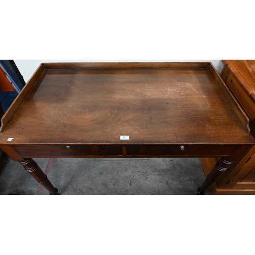 66 - An antique mahogany dressing table with two drawers and turned supports, 114 cm w x 60 cm d x 80 cm ... 