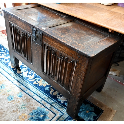 67 - An antique oak linenfold carved coffer, panelled construction with hinged top, 110 cm w x 50 cm d x ...