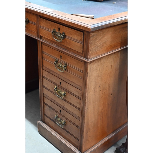 70 - Jas Shoolbred & Co (stamped) - a late Victorian walnut twin pedestal desk with nine drawers, 120... 