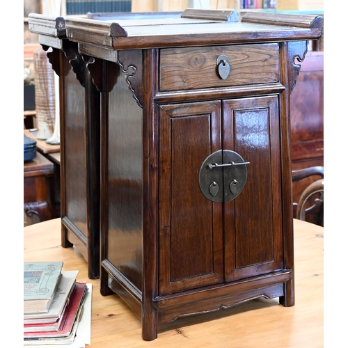 73 - A pair of 20th century Chinese stained elm bedside cabinets with brass fittings, each with single dr... 