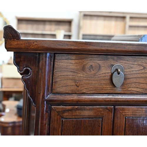 73 - A pair of 20th century Chinese stained elm bedside cabinets with brass fittings, each with single dr... 