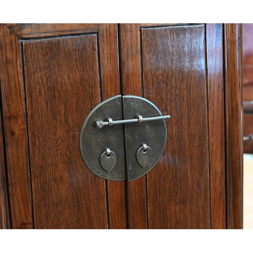 73 - A pair of 20th century Chinese stained elm bedside cabinets with brass fittings, each with single dr... 