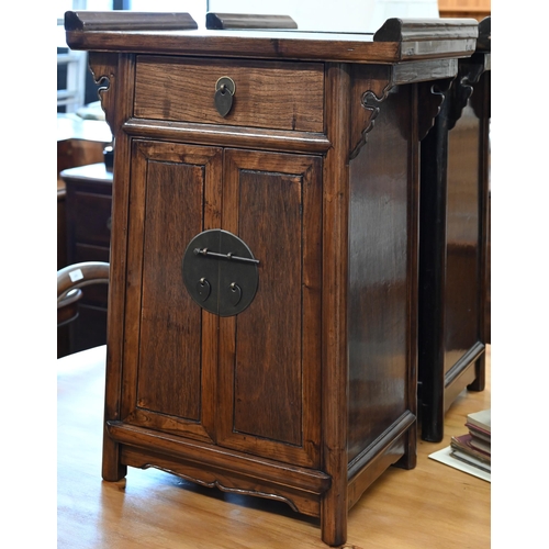 73 - A pair of 20th century Chinese stained elm bedside cabinets with brass fittings, each with single dr... 