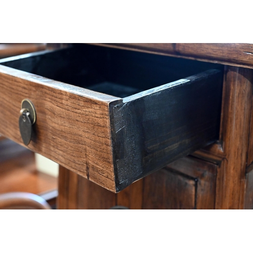 73 - A pair of 20th century Chinese stained elm bedside cabinets with brass fittings, each with single dr... 