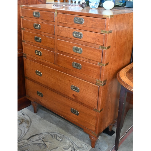 77 - A teak and brass mounted campaign style chest with arrangement of ten drawers with recessed handles,... 