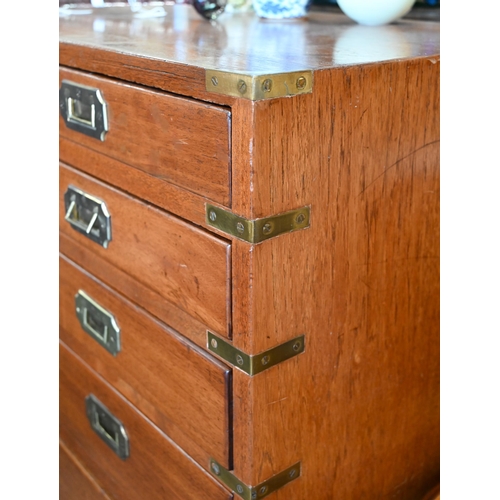 77 - A teak and brass mounted campaign style chest with arrangement of ten drawers with recessed handles,... 