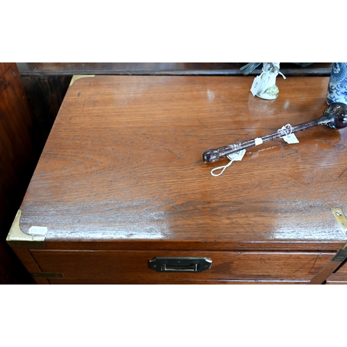 77 - A teak and brass mounted campaign style chest with arrangement of ten drawers with recessed handles,... 