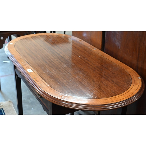 78 - An Edwardian mahogany hall table with crossbanded oval top over a frieze drawer raised on tapering s... 