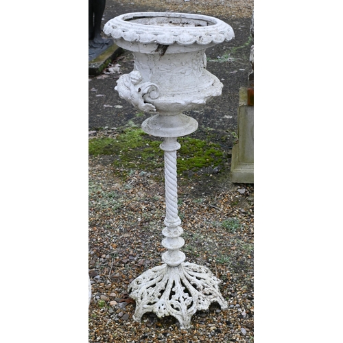 8 - A weathered cast stone garden cast urn planter raised on a square plinth to/with a Victorian style p... 