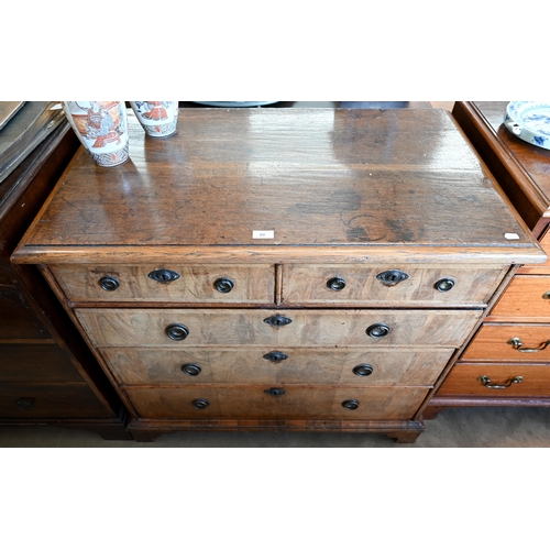 89 - An 18th century and later oak and walnut chest of two short over three long drawers on bracket feet,... 