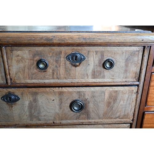 89 - An 18th century and later oak and walnut chest of two short over three long drawers on bracket feet,... 