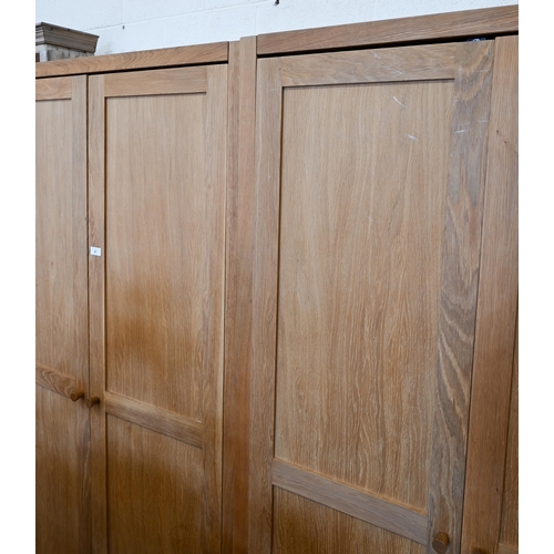 94 - # Two modern light oak wardobes, the twin panelled doors enclosing hanging rails, 100 cm w x 60 cm d... 