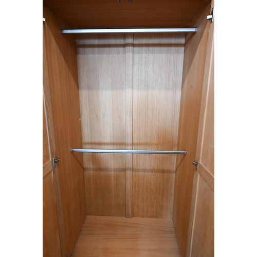 94 - # Two modern light oak wardobes, the twin panelled doors enclosing hanging rails, 100 cm w x 60 cm d... 