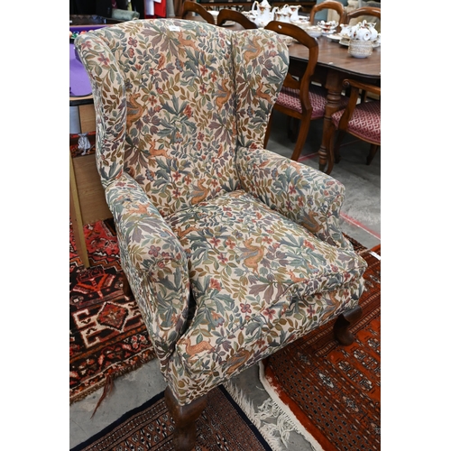 186 - An antique mahogany framed wingback armchair with flora and fauna upholstery, 76 x 85 x 102 cm