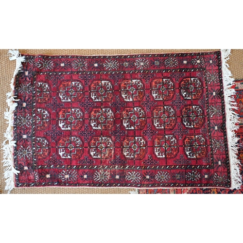 212 - A Persian Hamadan runner with five floral medallions on dark red ground, 333 x 89 cm to/w a Turkoman... 