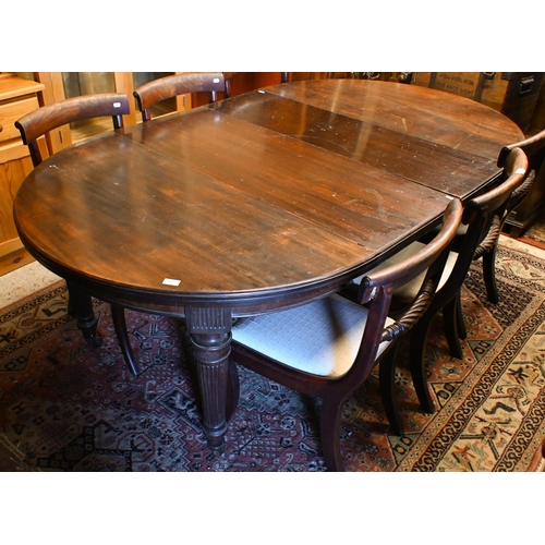 227 - # A late 19th century mahogany extending dining table, oval top with two central leaves on reeded tu... 