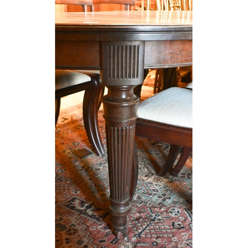 227 - # A late 19th century mahogany extending dining table, oval top with two central leaves on reeded tu... 