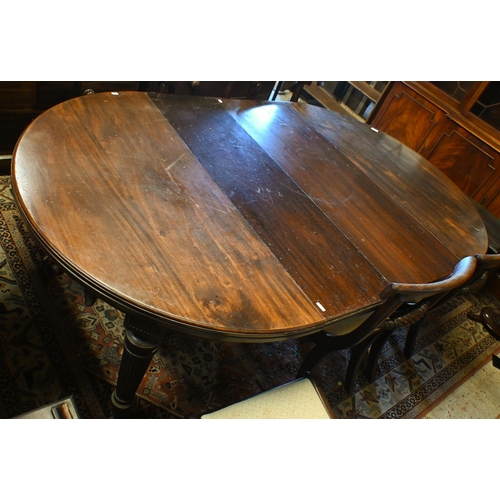 227 - # A late 19th century mahogany extending dining table, oval top with two central leaves on reeded tu... 