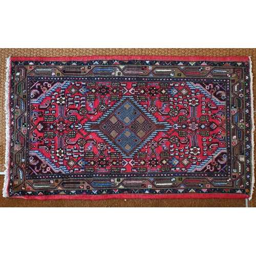 256 - A small Persian Hamadan rug, red ground  with single lozenge central medallion and stylised floral d... 