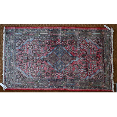 256 - A small Persian Hamadan rug, red ground  with single lozenge central medallion and stylised floral d... 