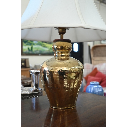 259 - A pair of hammered brass table lamps c/w shades, 56 cm high